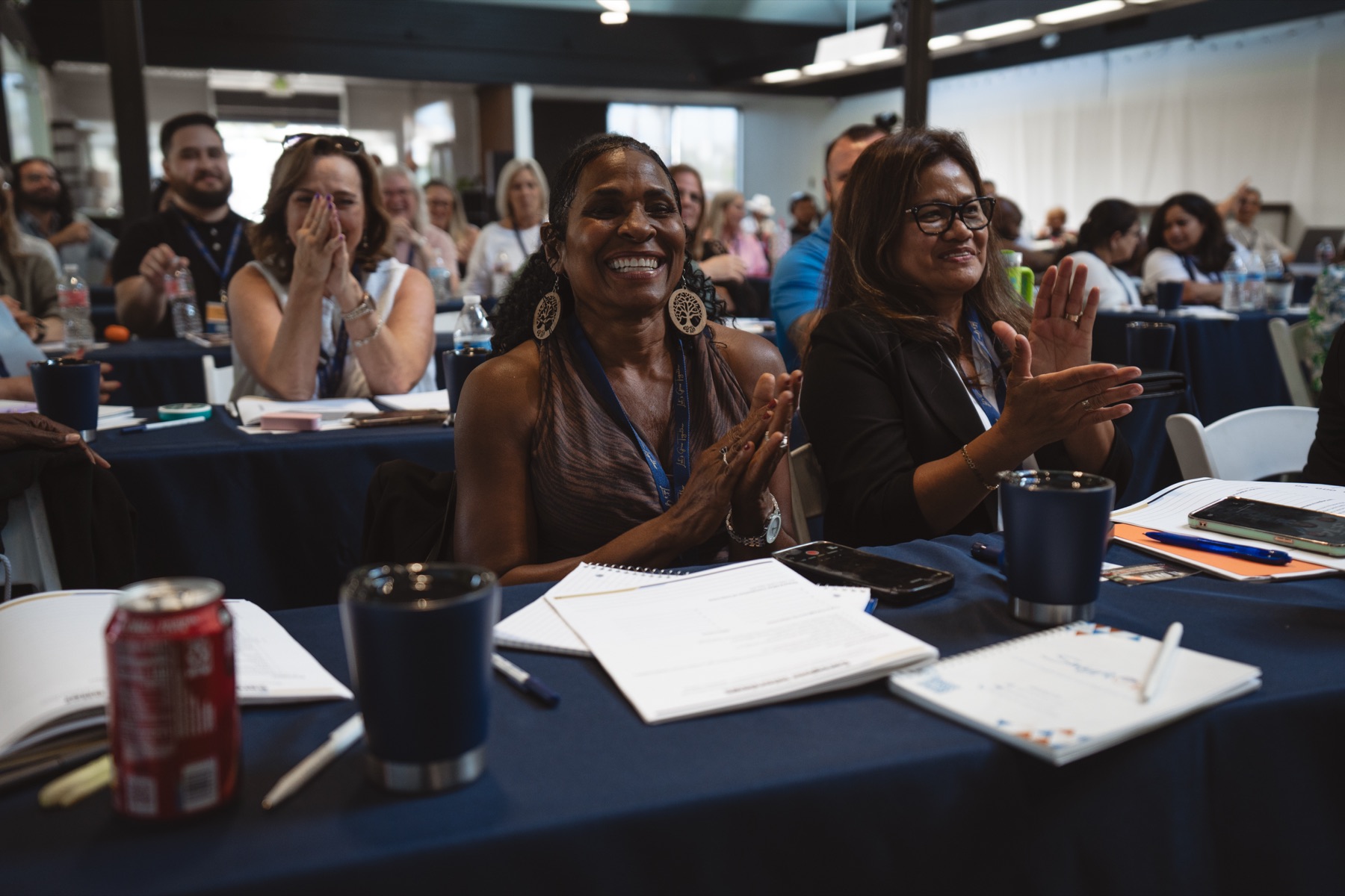 Attendees smiling and applauding at the Home Care Champions Experience
